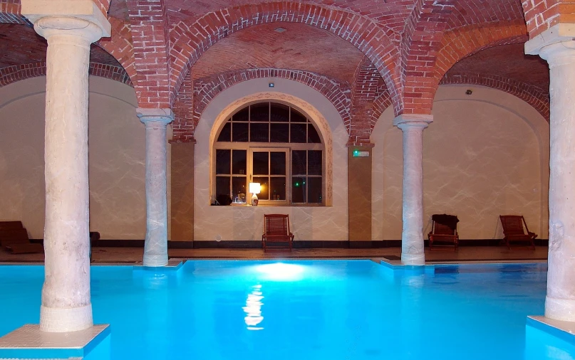 there is a pool in the middle of a building, art nouveau, brick, small wellness relaxation pool, located in a castle, marzanna