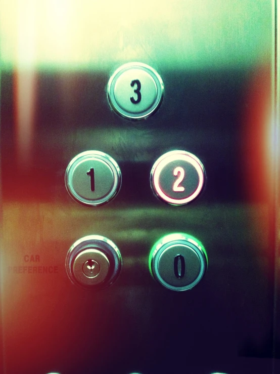 a close up of a bunch of buttons on an elevator, flickr, precisionism, threes, with a spooky filter applied, numerical, one car