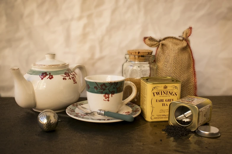 a teapot sitting on top of a table next to a cup and saucer, a still life, inspired by William Twigg-Smith, pixabay, ingredients on the table, products shot, 1 9 1 0 s style, taken from the high street