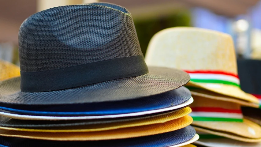 a stack of hats sitting on top of each other, a picture, plasticien, tipping his fedora, solid colours material, crypto, blocking the sun