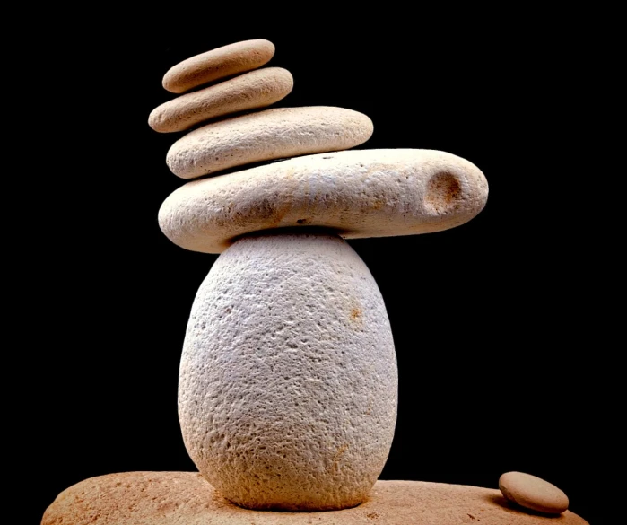 a pile of rocks stacked on top of each other, a marble sculpture, minimalism, on black background, enhanced photo, sandstone, miro