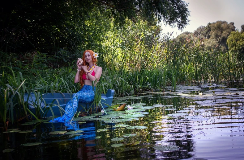 a woman sitting on top of a boat in a body of water, a photo, inspired by John William Waterhouse, renaissance, triss merigold cosplay, sitting at a pond, mermaids and fish, ❤🔥🍄🌪