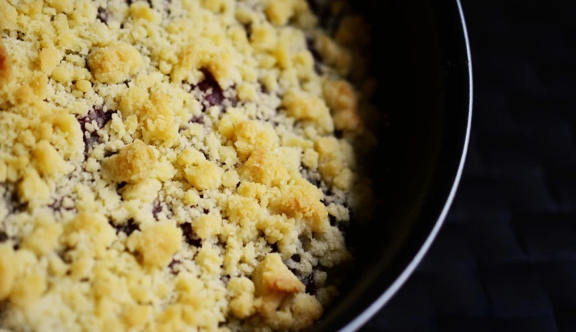 a close up of a pan of food on a table, by Carey Morris, unsplash, powdered sugar, blueberry, crisp detail, bottom - view