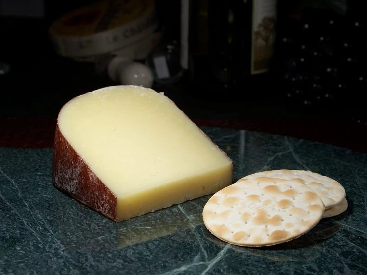 a piece of cheese sitting next to a cracker, flickr, celtic, sharp!, handsome, velvety