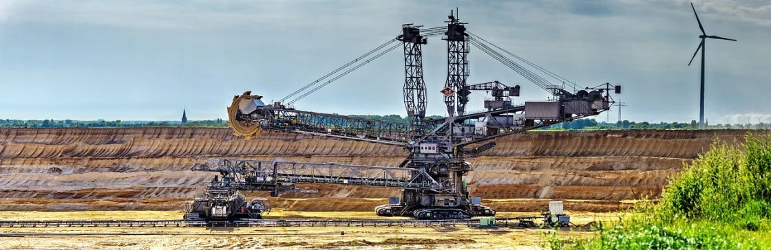a large crane sitting on top of a dirt field, by Werner Gutzeit, shutterstock, renaissance, intricate mine, highly contrasted elements, terminal, tourist photo