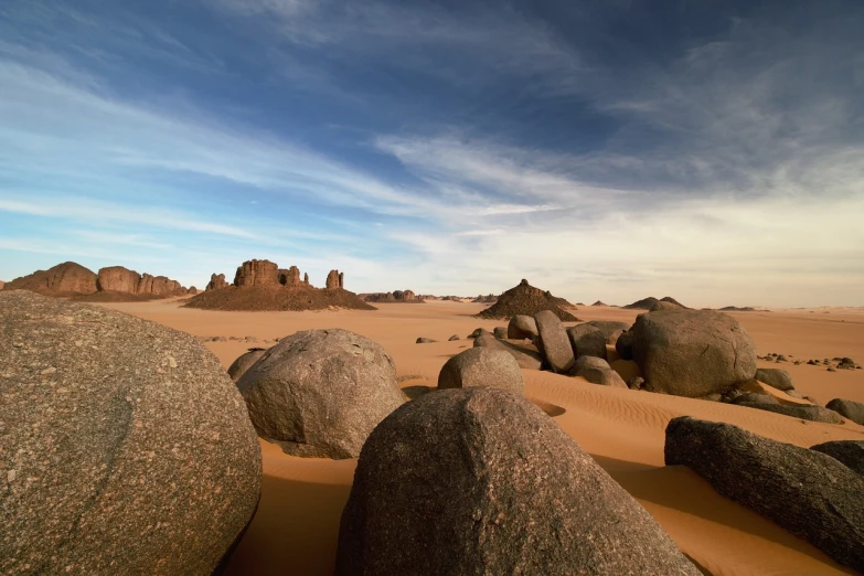 a group of large rocks sitting on top of a sandy beach, les nabis, sahara desert, reportage photo