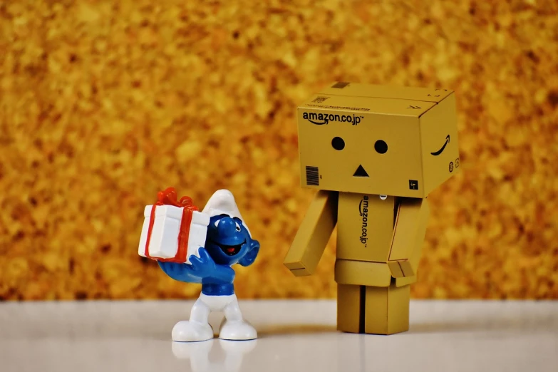 a couple of figurines standing next to each other, a picture, by Sam Havadtoy, reddit contest winner, delivering packages for amazon, blue and gold, cute toy, wikimedia commons