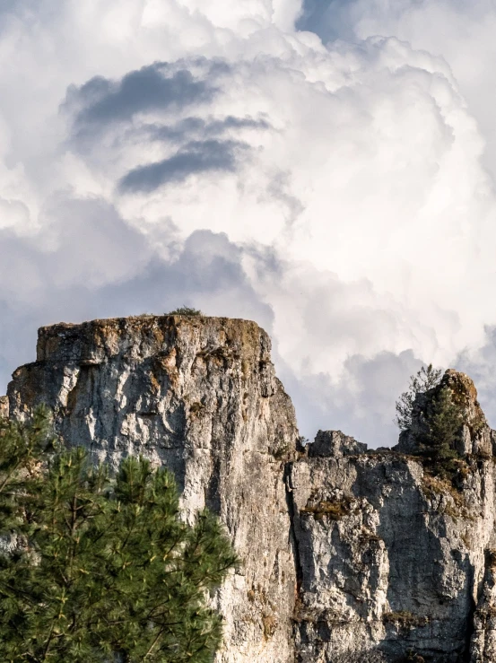 a couple of animals standing on top of a mountain, by Ivan Grohar, unsplash, romanticism, limestone, giant clouds, panorama, middle close up composition