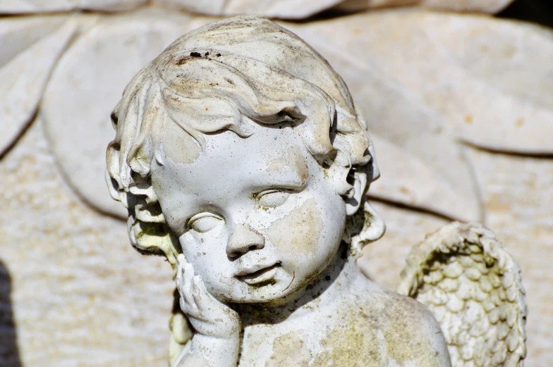 a close up of a statue of a child, by Marie Angel, trending on pixabay, shaded, angel relief, bashful expression, technological anguish