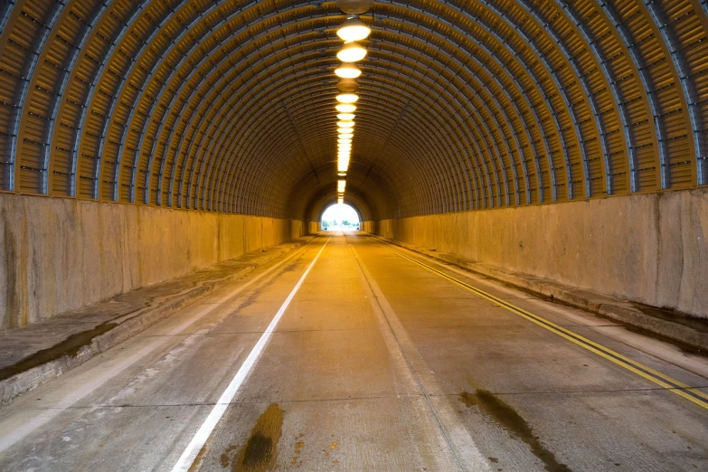 a tunnel with a light at the end of it, by Wayne England, shutterstock, highways, napa, exposed inner structure, colorado