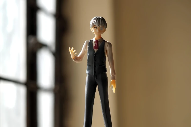 a close up of a figurine of a person, inspired by Sadamichi Hirasawa, unsplash, kaworu nagisa, wearing a strict business suit, standing in corner of room, shrugging arms