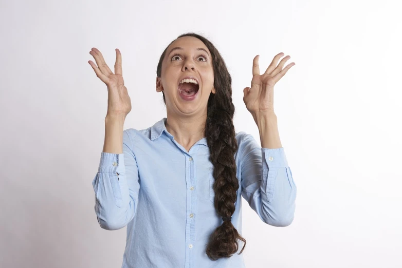 a woman making a funny face with her hands, a stock photo, antipodeans, the man is screaming and sad, girl with plaits, show from below, very excited