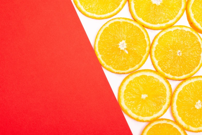 a close up of sliced oranges on a red and white background, by Joseph-Marie Vien, trending on unsplash, postminimalism, background image, product introduction photo