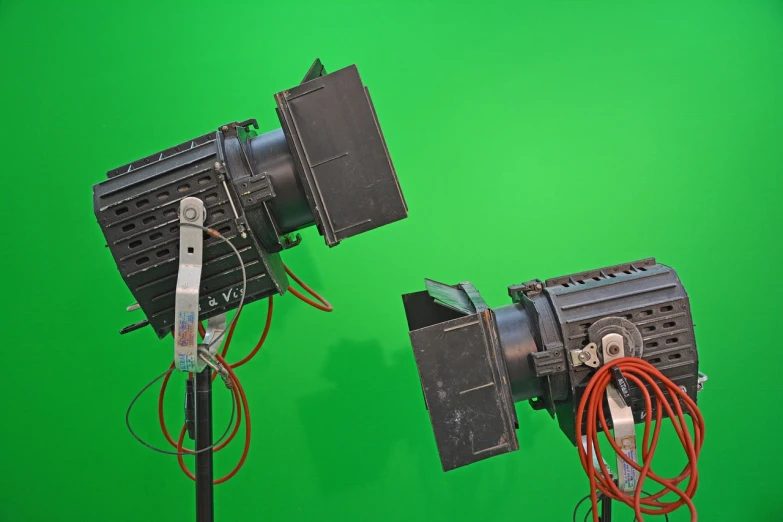 a couple of lights sitting on top of a green screen, by Wayne England, shutterstock, volumetric search lights, panavision psr r-200, medium shot taken from behind, technological screens