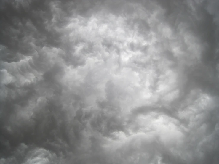 a large jetliner flying through a cloudy sky, by Alexander Scott, flickr, romanticism, dark mammatus cloud, a close-up, gradient white to silver, ( few clouds )
