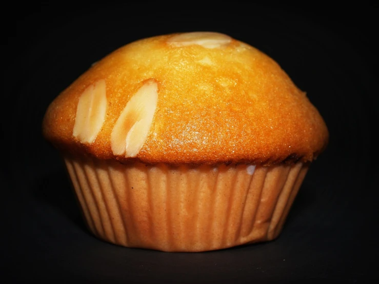 a close up of a muffin on a table, by Bernardino Mei, hurufiyya, on black background, wikimedia commons, antoine pierre mongin, pastelle