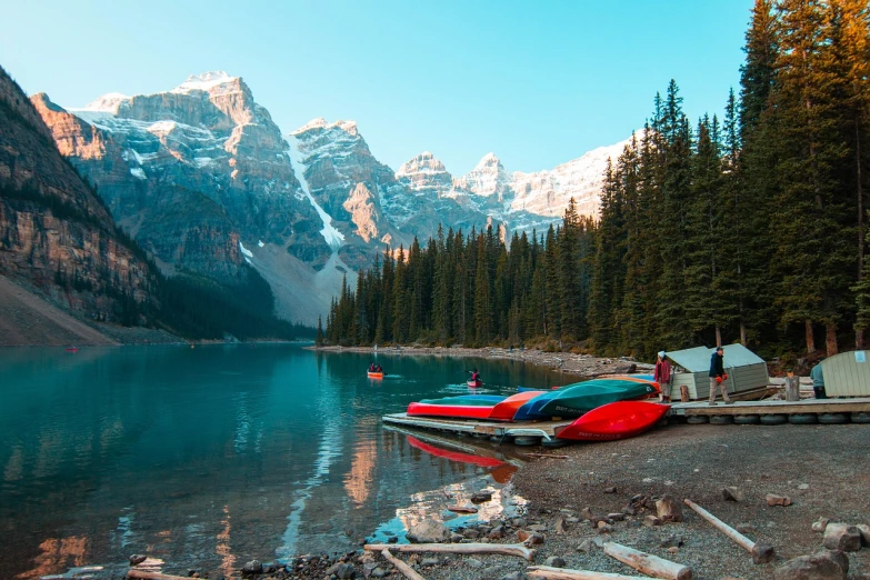 a couple of boats sitting on top of a lake, by George Abe, pexels contest winner, bakelite rocky mountains, 🦩🪐🐞👩🏻🦳, toronto, camp