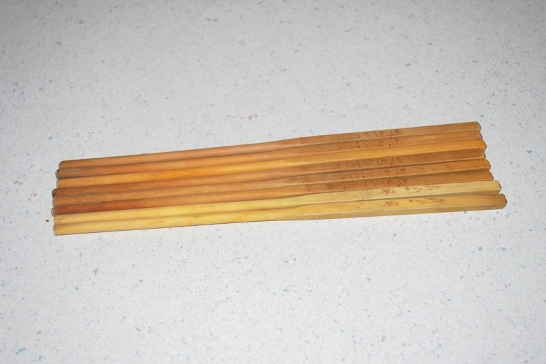 a group of wooden sticks sitting on top of a table, ebay, yellow broad sword, whole-length, vintage - w 1 0 2 4