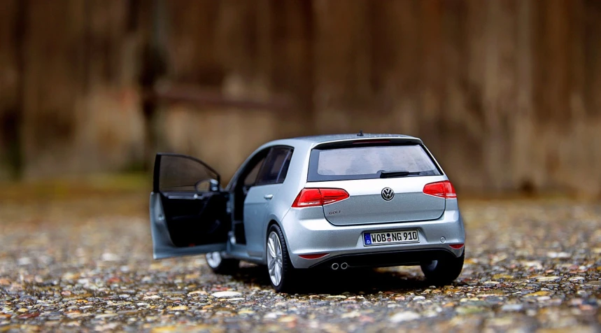 a toy car that is sitting on the ground, a picture, by Hans Schwarz, unsplash, happening, half rear lighting, very very very realistic, photo of a model, grey metal body