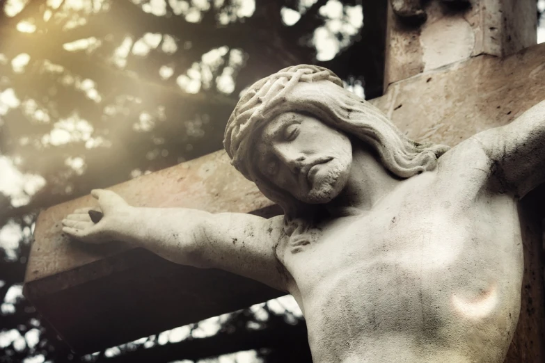 a close up of a statue of jesus on a cross, by Kurt Roesch, unsplash, with a spooky filter applied, vintage photo, sunlit, denoised