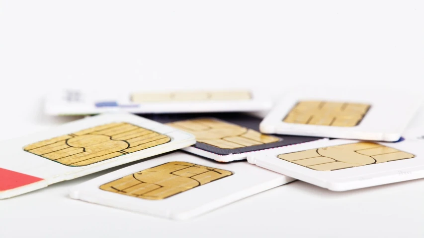 a pile of sim cards sitting on top of each other, shutterstock, modernism, with a white background, a wooden, small chin, numerical