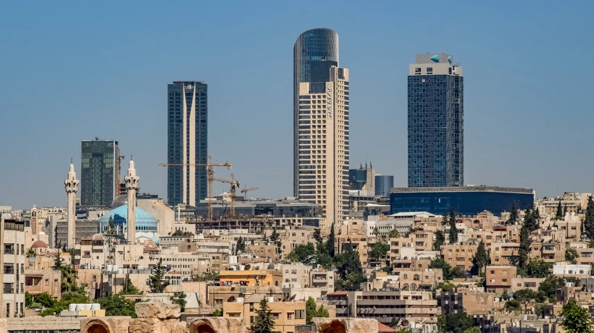 a couple of cows standing on top of a lush green field, dau-al-set, city buildings on top of trees, brutalist buildings tower over, jerusalem, the city iacon cybertron