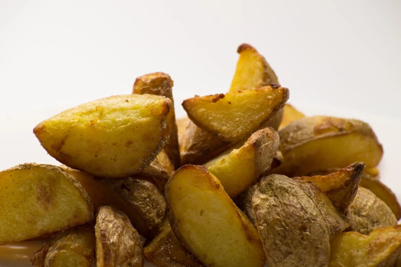 a pile of potatoes sitting on top of a white plate, by Kazimierz Wojniakowski, close-up product photo, high detail product photo, fry, hard angles