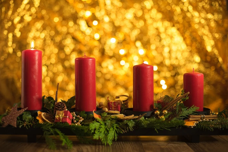 a group of red candles sitting on top of a wooden table, shutterstock, gold decorations, bokeh backdrop, garner holt, red and yellow scheme