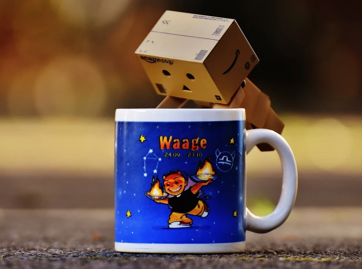 a coffee mug with a cardboard block on top of it, a picture, inspired by Muggur, pixabay contest winner, happening, wake cyborgs from hypersleep, happy brave magical cuteness, waporware, warm glow
