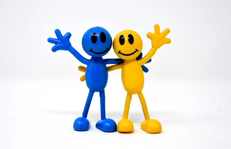 a couple of toy figures standing next to each other, a picture, figuration libre, smiley, long arms, blues, pvc figurine