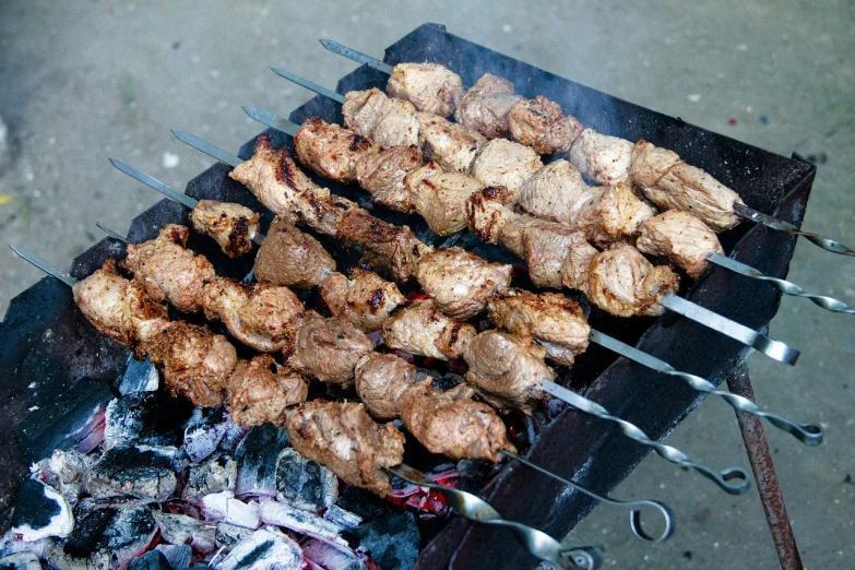 a close up of a grill with meat on skewers, dau-al-set, nekro petros afshar, high quality product image”