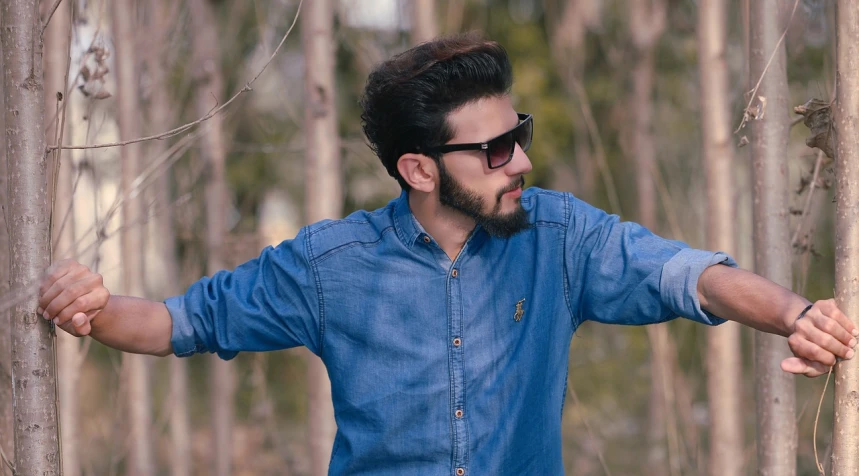 a man that is standing in the woods, a picture, inspired by Jitish Kallat, pexels, romanticism, wearing blue sunglasses, wearing a shirt and a jean, avatar image, various poses shooting photos