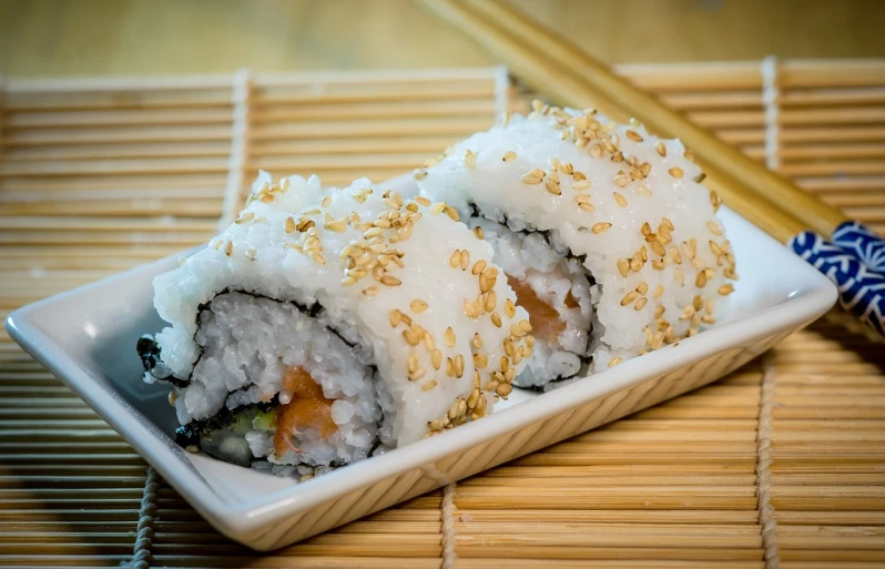 a close up of a plate of food with chopsticks, inspired by Maki Haku, pixabay, luscious with sesame seeds, white and orange, istock, closeup photo