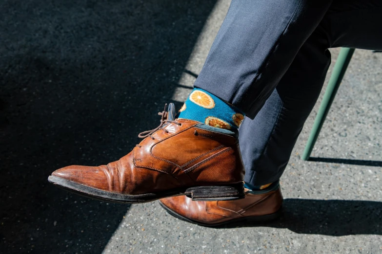 a close up of a person wearing a pair of shoes, a portrait, by Etienne Delessert, orange slices, san francisco, blue tie, wearing boots