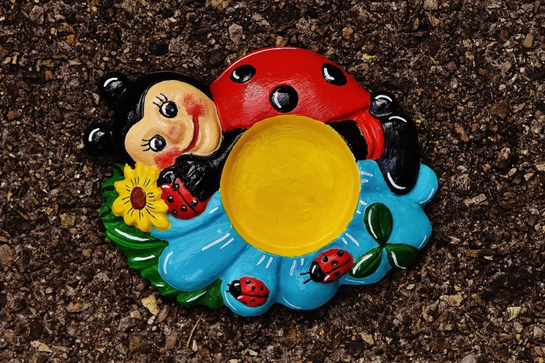 a statue of a ladybug sitting on top of a flower, by Hans Schwarz, naive art, ashtray, close-up product photo, cute girl, under a spotlight
