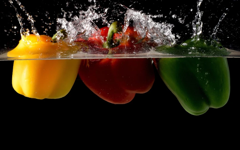 a group of peppers splashing into the water, a picture, by Jan Rustem, hydroponic farms, flash photography, bob pepper, underwater photography