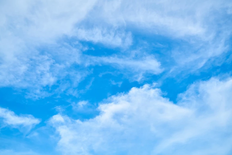 a large jetliner flying through a blue sky, a stock photo, minimalism, lie on white clouds fairyland, clouds of vivid horse-hair wigs, blue sky with beautiful clouds, whorl. clouds