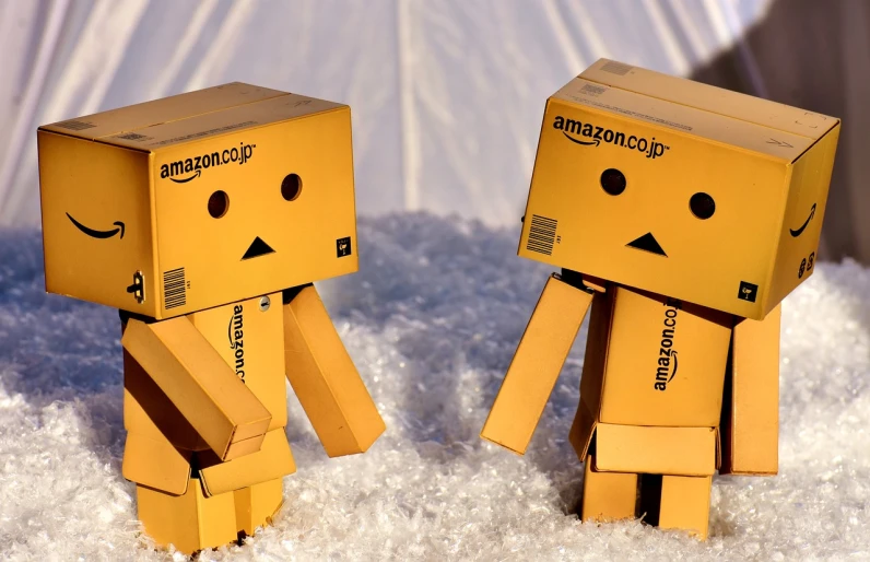 a couple of cardboard boxes sitting on top of a snow covered ground, a cartoon, reddit, amazon, the mekanik doll, humans, cubes