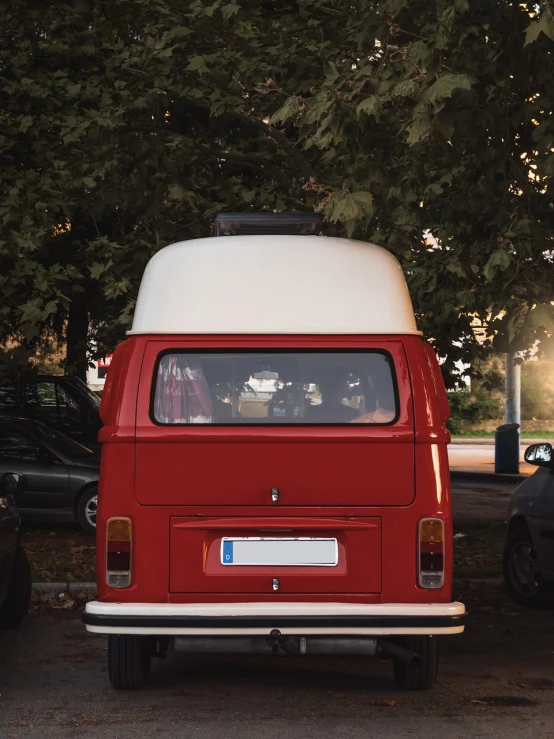 a red and white van parked in a parking lot, by Matthias Weischer, unsplash contest winner, renaissance, hippie, rear facing, window open, looking cute