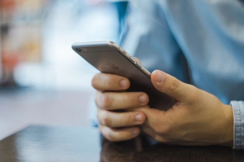 a close up of a person holding a cell phone, happening, sitting down, smooth edges, online, istockphoto