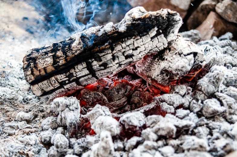 a pile of wood sitting on top of a pile of coal, a photo, pexels, orange fire/blue ice duality!, close up food photography, my blood is boiling, nostalgic and euphoric