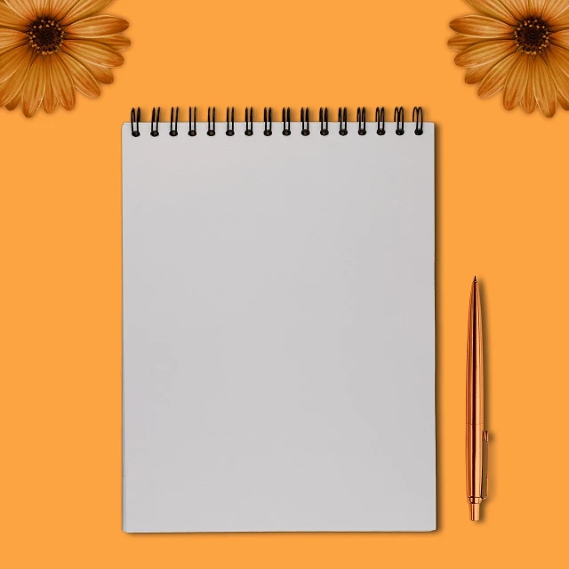a notepad with a pen and flowers on an orange background, a minimalist painting, conceptual art, golden hour photo, white sketchbook style, photorealistic photo, product introduction photo