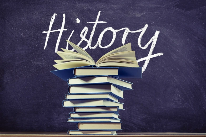 a stack of books sitting on top of a wooden table, by Julian Hatton, pixabay, graffiti, history channel, blackboard in background, alternate history, with text
