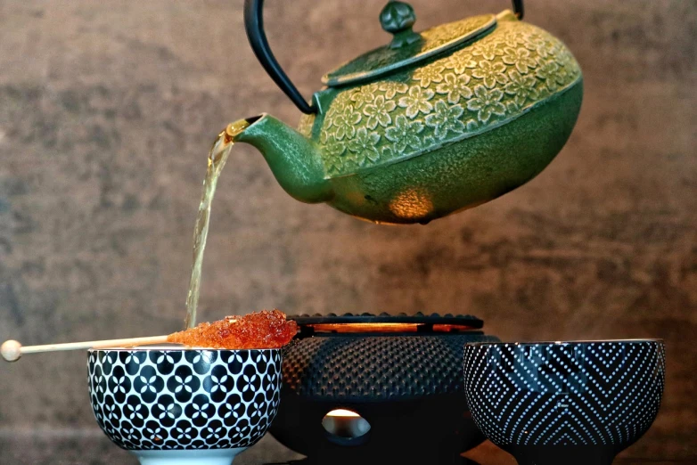 a tea pot pouring tea into a cup, by Dietmar Damerau, pexels, intricately detailed textures, red caviar instead of sand, tatsumaki, alamy stock photo