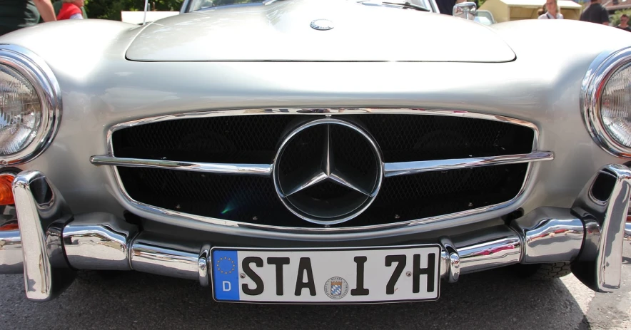 a silver mercedes benz benz benz benz benz benz benz benz benz benz benz benz benz benz benz, a photo, inspired by Oskar Lüthy, shutterstock, stuckism, vintage - w 1 0 2 4, stern face, stingray, stained”