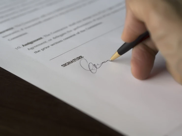 a person signing a document with a pencil, very sharp photo, - signature, dsrl photo, good shading