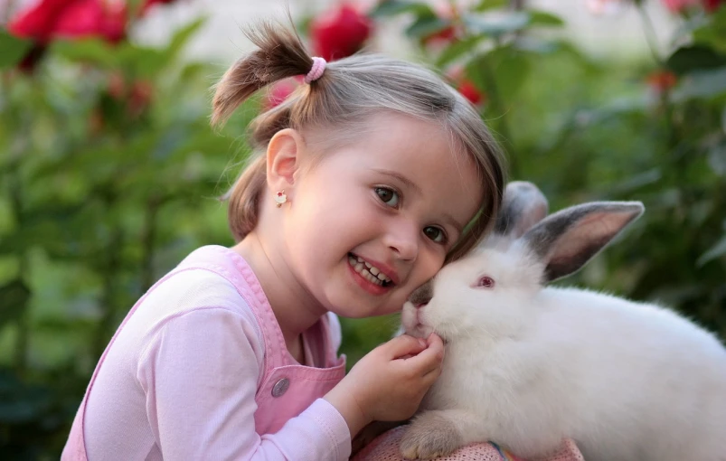 a little girl sitting next to a white rabbit, a picture, istockphoto, two pigtails hairstyle, with a beautifull smile, small animals