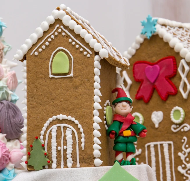 a close up of a gingerbread house on a table, a picture, by Aleksander Gierymski, shutterstock, in the white clouds fairyland, an elf in a suit, profile close-up view, wide shot photo