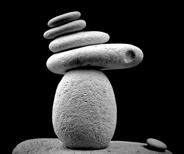 a stack of rocks sitting on top of each other, an abstract sculpture, by János Nagy Balogh, minimalism, moonwalker photo, on black background, 15081959 21121991 01012000 4k, balanced colors