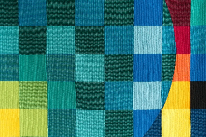 a colorful rug with squares of different colors, a mosaic, inspired by Johannes Itten, geometric abstract art, detail shot, cyan and green, 8 k detail, weaving